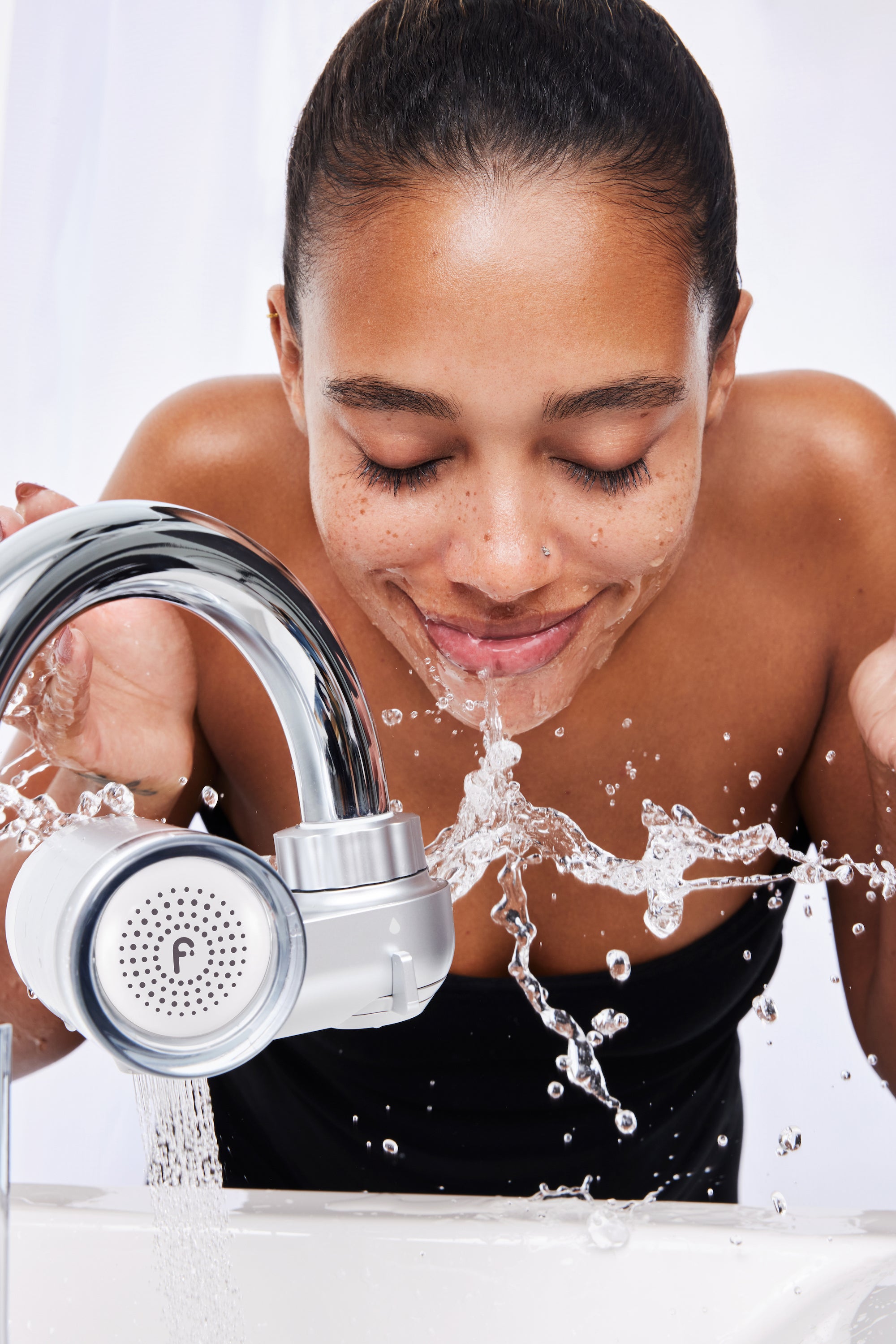 Filtered shower water running over skin and hair